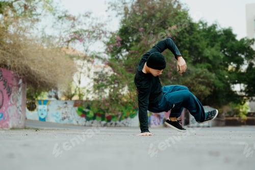 Preview: Full length shot of attractive male practicing b-boy dance on the street