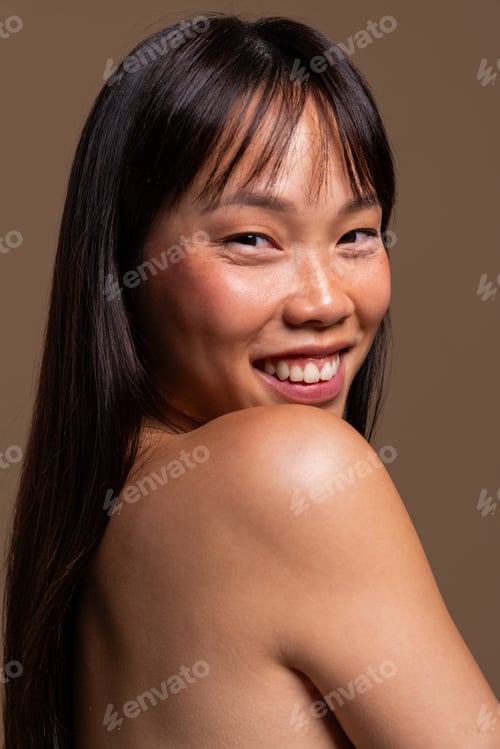 Preview: Beautiful asian woman portrait, asian woman smiling looking over her shoulder