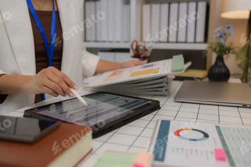 Preview: a businesswoman is using an electronic device to search and send information to her team