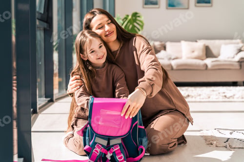 Preview: Mom and daughter are preparing schoolbag