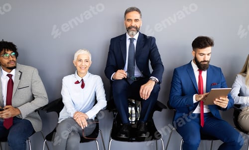 Preview: Group of friendly businesspeople with male leader in front