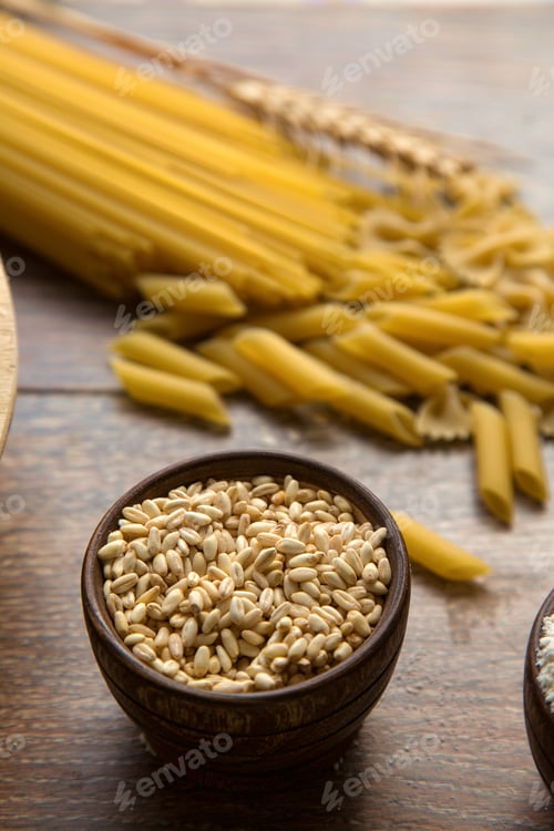 Preview: Variety of Uncooked Pasta and Grains in Bowls