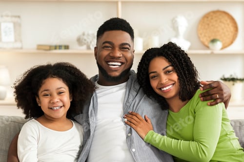Preview: Happy Family Smiling at Home on the Sofa