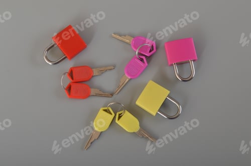 Preview: Colorful padlocks and keys isolated on a grey background