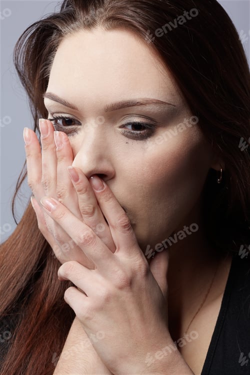 Preview: Portrait Of Beautiful Crying Girl With Smeared Mascara Hiding Her Face In Hands
