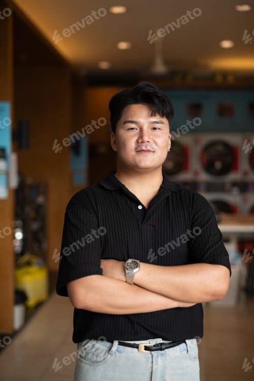 Preview: Young Asian man in laundry shop