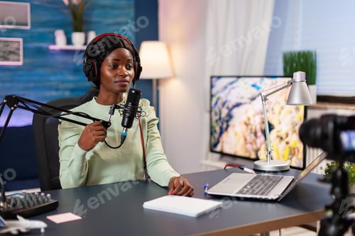 Preview: Afro blogger recording podcast talking into microphone
