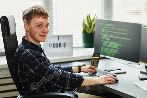 Preview: Young programmer working with codes on computer