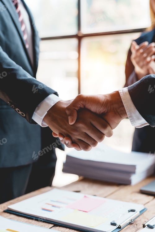 Preview: Business people shaking hands during a meeting.