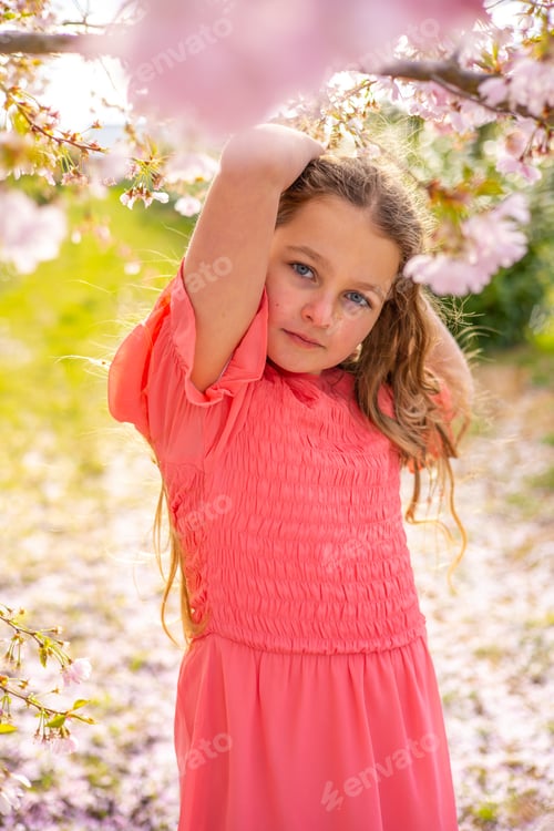 Preview: teenager girl ten years old in a blooming sakura garden,spring,blooming,portrait