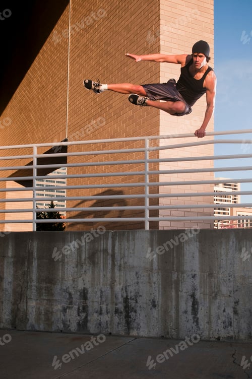 Preview: Athlete jumping over urban wall