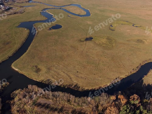 Preview: aerial view of a beautiful winding river flows among the fields, which flows picturesquely, creat