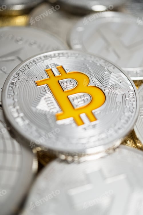 Preview: Close-Up Of Bitcoin Physical Coin On Stack Of Many Other Cryptocurrencies