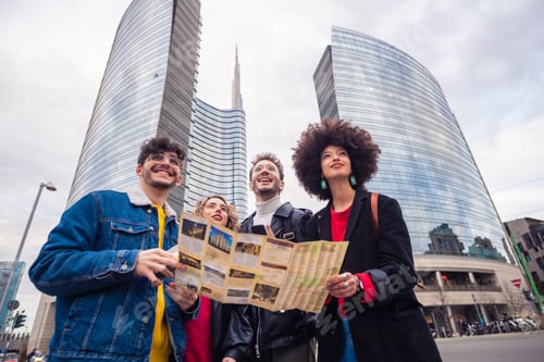 Preview: Four multiethnic people tourist using map