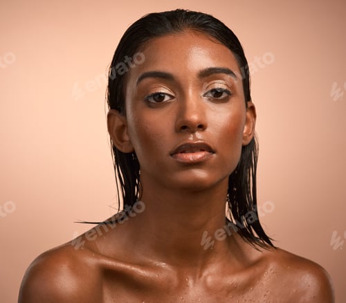 Preview: Portrait of a beautiful young woman after having a refreshing shower against a brown background