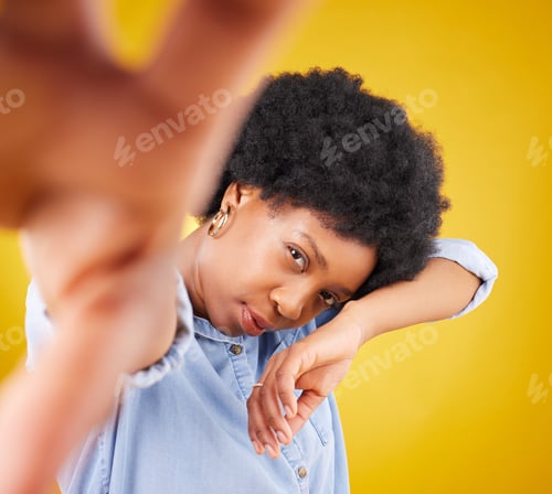 Preview: Hand, selfie and black woman in studio for fashion, creative and pose against a yellow background.