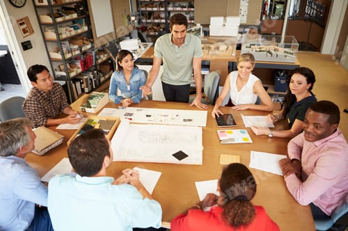 Preview: Group Of Architects Sitting Around Table Having Meeting