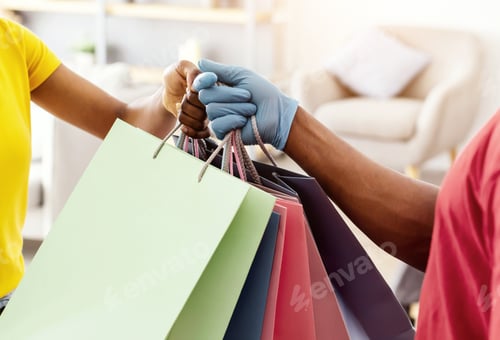 Preview: Black Woman Receiving Shopping Bags From Courier At Home, Cropped