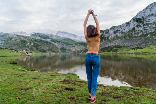 Preview: Woman Stretching by a Calm Lake in Nature