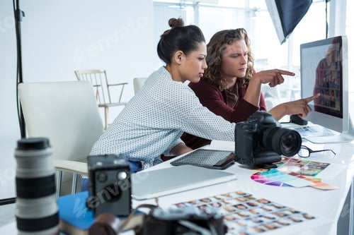 Preview: Photographers working over computer