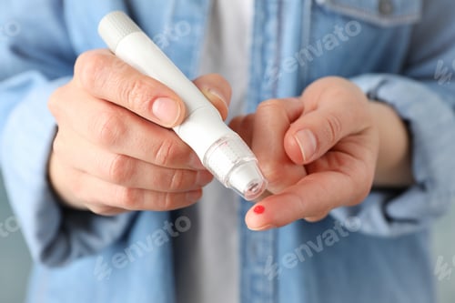 Preview: Woman checking blood sugar level, close up