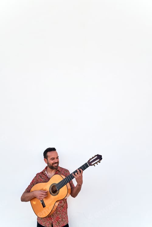 Preview: Man Plays Acoustic Guitar Against White Wall
