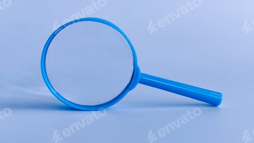 Preview: Blue Magnifying Glass on Blue Background Representing Search, Focus, and Investigation