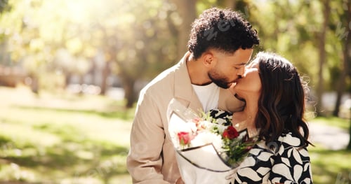 Preview: Kiss, gift and couple with flowers, outdoor and celebration for anniversary for people and romance.