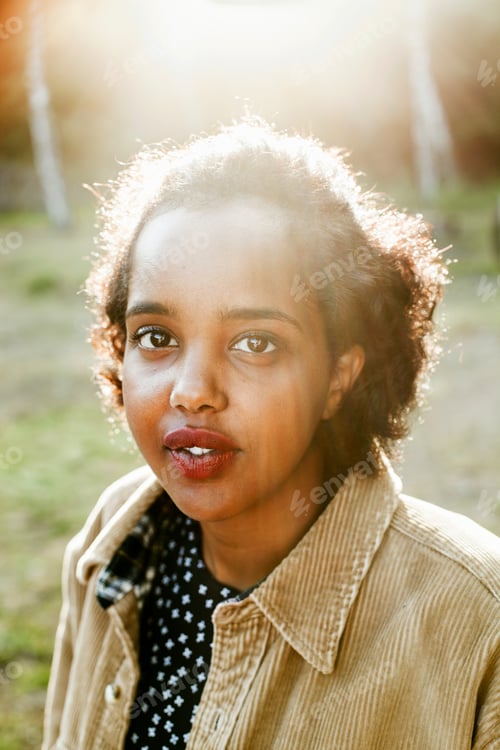 Preview: Portrait of woman standing in forest on sunny day