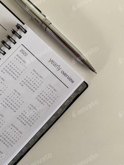 Preview: Daily planner and pen on white background