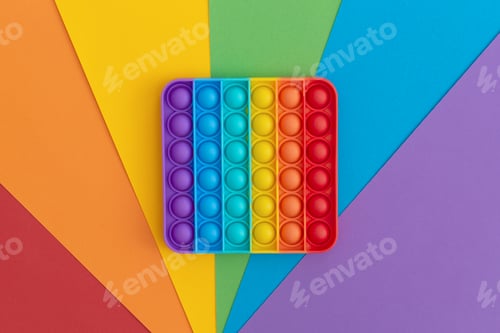 Preview: Colorful anti-stress pop it sensory toys for children on multicolored background.
