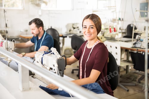 Preview: Pretty woman using a sewing machine