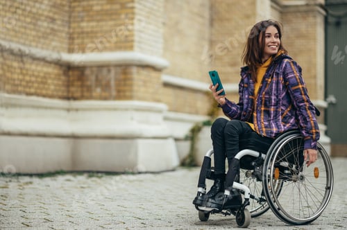 Preview: Woman with disability using a smartphone while out in the city