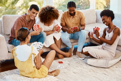 Preview: Game, happy or friends playing cards, poker or black jack at home for gambling together in a holida