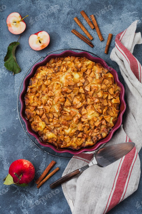 Preview: Apple and cinnamon homemade pie with walnuts and custard on an old concrete background. Rustic style
