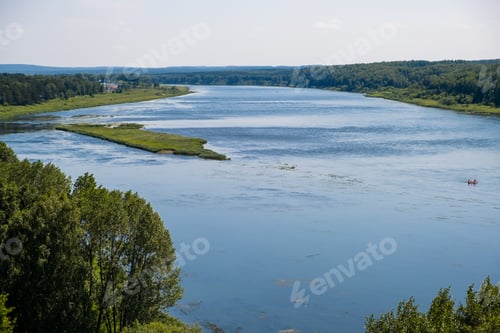 Preview: Beautiful, wide autumn river among forests and rocky shore.