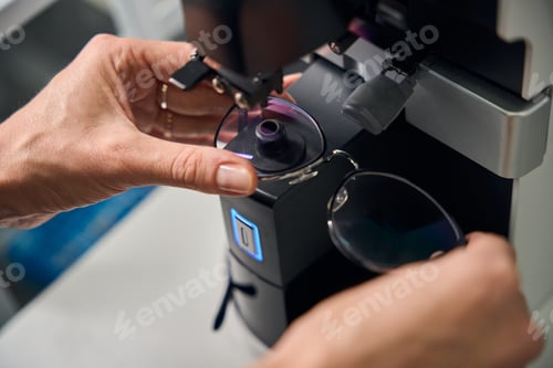 Preview: Optician adjusting glasses in a measuring device