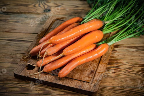 Preview: Fresh carrots on wooden table.