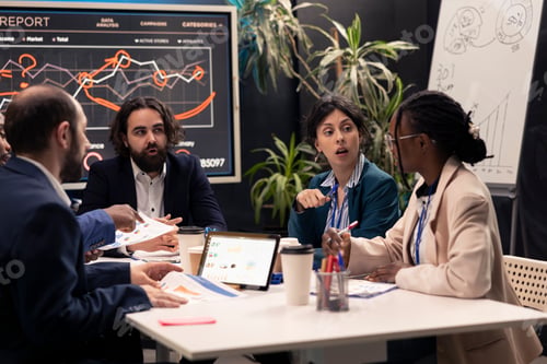 Preview: Colleagues evaluating infographics data analysis in an executive meeting