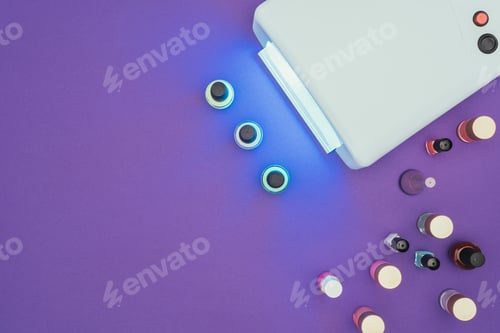 Preview: top view of uv lamp light and nail polishes