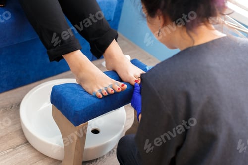 Preview: Person receives pedicure in a salon during daytime