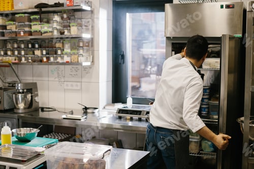 Preview: The chef prepares food in the modern spacious kitchen.