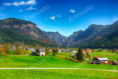 Preview: Alpine green fields and traditional wooden houses view of the Gosau village at autumn sunny day.