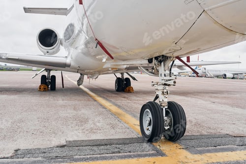 Preview: View from below. Turboprop aircraft parked on the runway at daytime