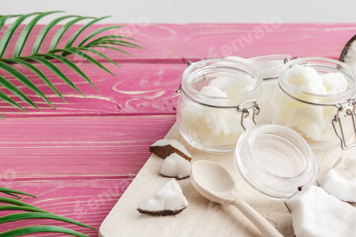 Preview: Coconut butter on wooden background. Organic healthy food concept