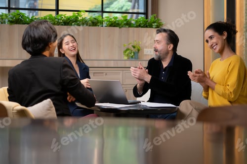 Preview: Group of business people discussing business plan at meeting table in office.