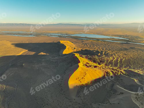 Preview: Singing Barkhan dune casting a long shadow at sunset