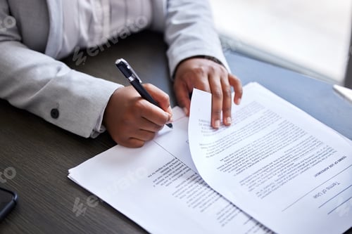 Preview: Cropped shot of a businesswoman signing paperwork in an office
