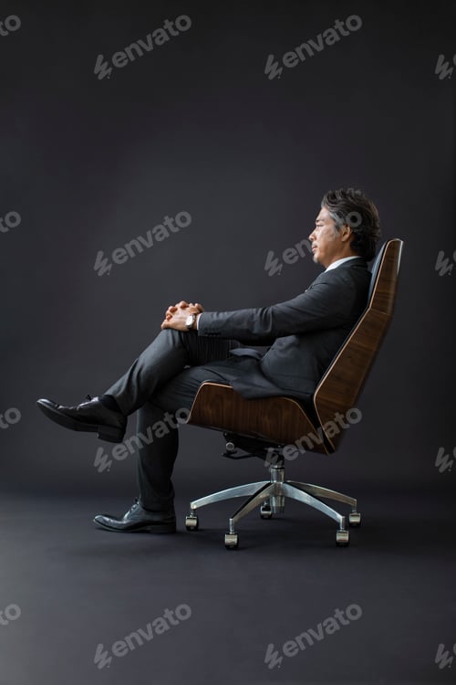 Preview: Relaxed Business Man Sitting in Modern Office Chair