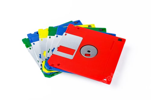 Preview: Different colored floppy disks stacked together for retro technology display